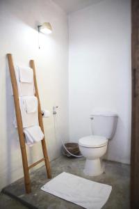 a bathroom with a toilet and a ladder and towels at Baannoi Nornmuan retreat vacation rental & workshop Chiang Mai in Chiang Mai