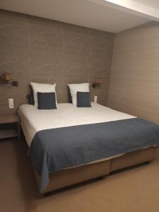 Voodi või voodid majutusasutuse Hotel Pavillon Du Zoute toas
