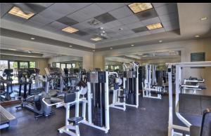 a gym with rows of treadmills and machines at 3 bedroom & 3bath villa near Irvine Spectrum Center UCI in Irvine