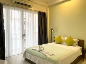 a bedroom with a bed with towels on it at Acorn Saigon Hotel - Bui Vien in Ho Chi Minh City
