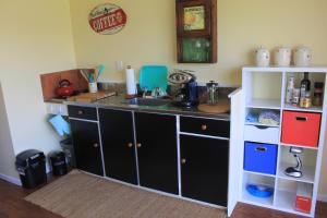 a kitchen with a sink and a counter top at Fig Tree Cottage in Greytown