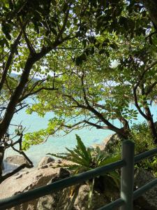a view of the ocean from a fence at Kata Noi Place floor3 in Kata Beach