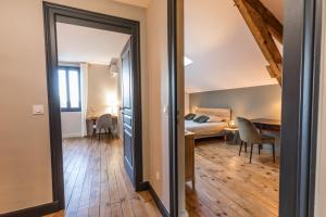 a bedroom with a bed and a table in a room at La maison d'à côté in Mont-de-Marsan