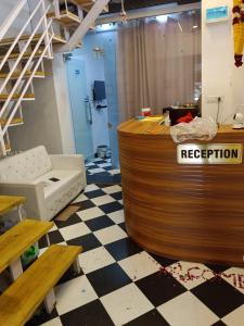 a reception counter in a room with a checkered floor at Hotel Balaji Residency in Udaipur