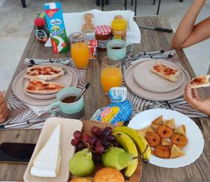 a table topped with plates of food and fruit at Rooftop in Flic-en-Flac