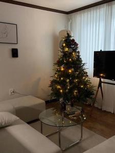 a living room with a christmas tree in a room at Maison de Haenggung in Suwon