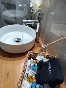a basket of wine bottles on a table next to a sink at Nini's House Superior Nydri - 100m from beach NYDRI TOWN CENTER in Nydri +23 photos