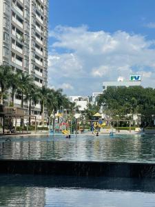 a pool of water with a playground in a city at SECC Scenic Valley Apartment in Ho Chi Minh City