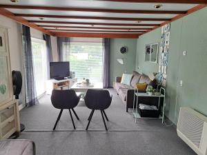 a living room with two chairs and a couch at Camping de Zandhorst, Eldorado in Wouterswoude