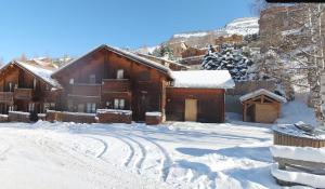a cabin in the snow with snow covered at Chalet Flocon 14p Les 2 alpes in Les Deux Alpes