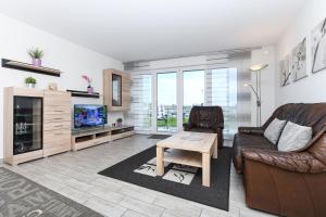 TV a/nebo společenská místnost v ubytování Residenz Hafenidyll