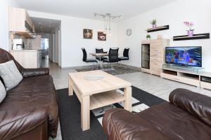 TV a/nebo společenská místnost v ubytování Residenz Hafenidyll