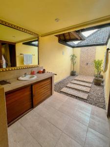 a bathroom with a sink and a mirror at Villa Bulan Madu Gili Air in Senaru