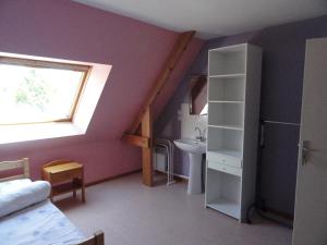 a attic room with a sink and a window at Chambre indépendante in Caen