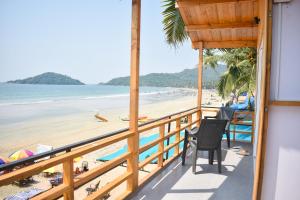 a balcony with a view of the beach at Home De francisco in Canacona