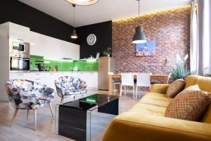 a living room with a couch and chairs and a kitchen at Apartment Zagreb Deluxe in Zagreb