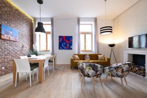 a living room with a couch and a table and chairs at Apartment Zagreb Deluxe in Zagreb