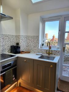 a kitchen with a sink and a window at Rose & Star Cottage in Frome