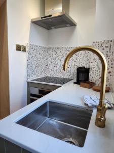 a kitchen with a sink and aaucet at Rose & Star Cottage in Frome