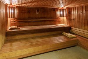 a wooden sauna with a bench in it at Logis Hôtel Le Rochelois in La Rochelle