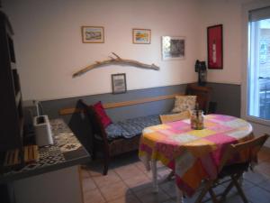 a room with a table and a bed and a table and chair at chambre les flamants vue sur les étangs petit déjeuner compris in Saintes-Maries-de-la-Mer