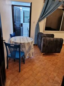a living room with a table and a couch at Charmant,bien localisé et lumineux Appartement F2M/401A in Douala +41 photos