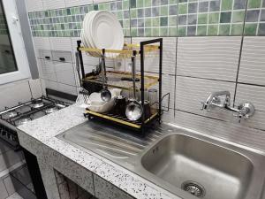 a kitchen counter with a sink and a plate at Charmant,bien localisé et lumineux Appartement F2M/401A in Douala
