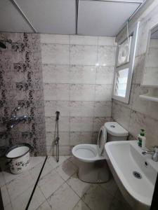 a bathroom with a toilet and a sink at 3 Bedroom with a beautiful green view in Hyderabad