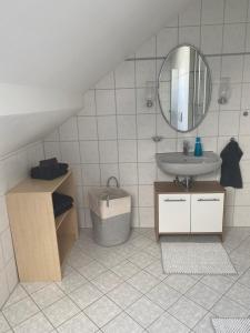 a bathroom with a sink and a mirror at Ferienwohnung Blumenau in Bad Berneck im Fichtelgebirge +18 photos