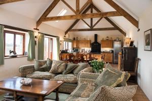 a living room with a couch and a table at Unique Rural Stone dog friendly Barn Conversion in Okehampton