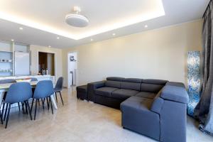 un salon avec un canapé et une cuisine dans l'établissement Sea front Costa Adeje Spacious 2 bedroom apartment, à Adeje