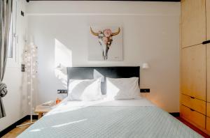 a bedroom with a bed with a skull on the wall at Newwww Kolonaki Split Rock KSR1 in Athens