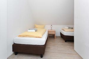 Postel nebo postele na pokoji v ubytování Haus Nordseesterne