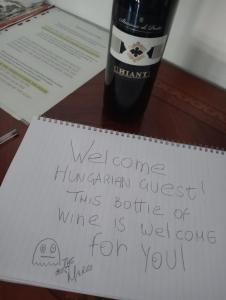 a piece of paper on a table with a bottle of wine at EUR Mostacciano - 6 ospiti WIFi AC in Rome