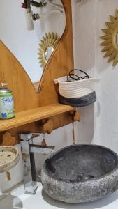 a bathroom with a stone sink and a mirror at Cocoon des sommets enneigés in La Foux