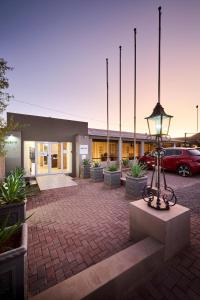 a building with a street light in front of it at Postmasburg d Olive Rose Boutique Hotel in Postmasburg