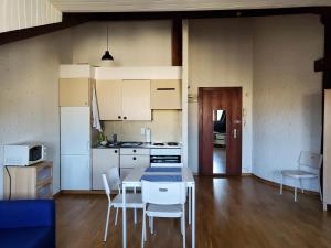 a kitchen with a table and chairs in a room at Studio au centre de Genève in Geneva