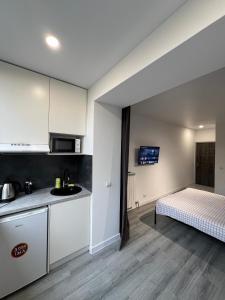 eine Küche und ein Schlafzimmer mit einem Bett in einem Zimmer in der Unterkunft Smart Modern loft apartments in Iwano-Frankiwsk