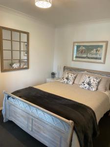 a bedroom with a large bed in a room at Church Street Villas in Stanley