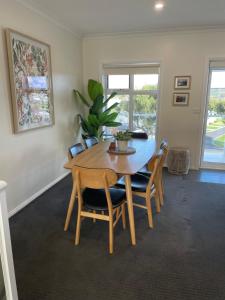 a dining room with a wooden table and chairs at Church Street Villas in Stanley