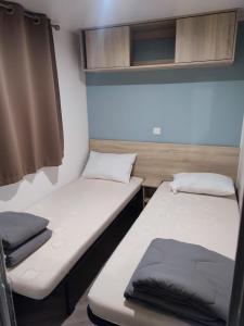 superbe mobil home 6/8 pers,clim, sans vis a vis dans camping 4* espace aquatique客房内的一张或多张床位