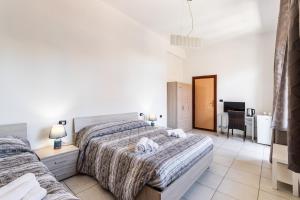 Posteľ alebo postele v izbe v ubytovaní Le Torrette Rooms and Apartments