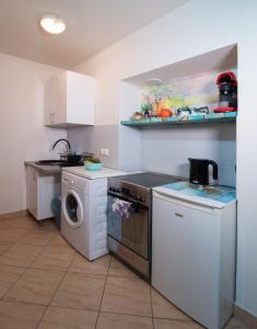 a kitchen with a washing machine and a washer at Cozy Apartament Rachel-Near Rynek and train station in Krakow