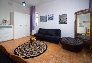 a living room with a couch and a table at Cozy Apartament Rachel-Near Rynek and train station in Krakow