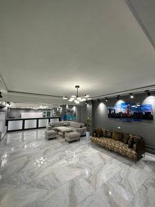 a large living room with couches and a marble floor at Gumbaz Luxury hotel in Bukhara