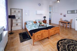 a bedroom with a bed and a couch in a room at Cozy Apartament Rachel-Near Rynek and train station in Krakow