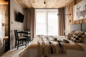 Posteľ alebo postele v izbe v ubytovaní ApartSki 18d