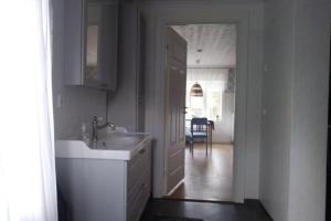 a white bathroom with a sink and a mirror at Lilla Skogstorp in Åseda +47 photos