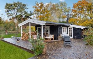 a log cabin with a deck in the yard at Nice Home In Nykbing Sj With Wifi in Tjørneholm