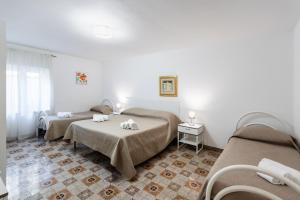 Posteľ alebo postele v izbe v ubytovaní Le Torrette Rooms and Apartments
